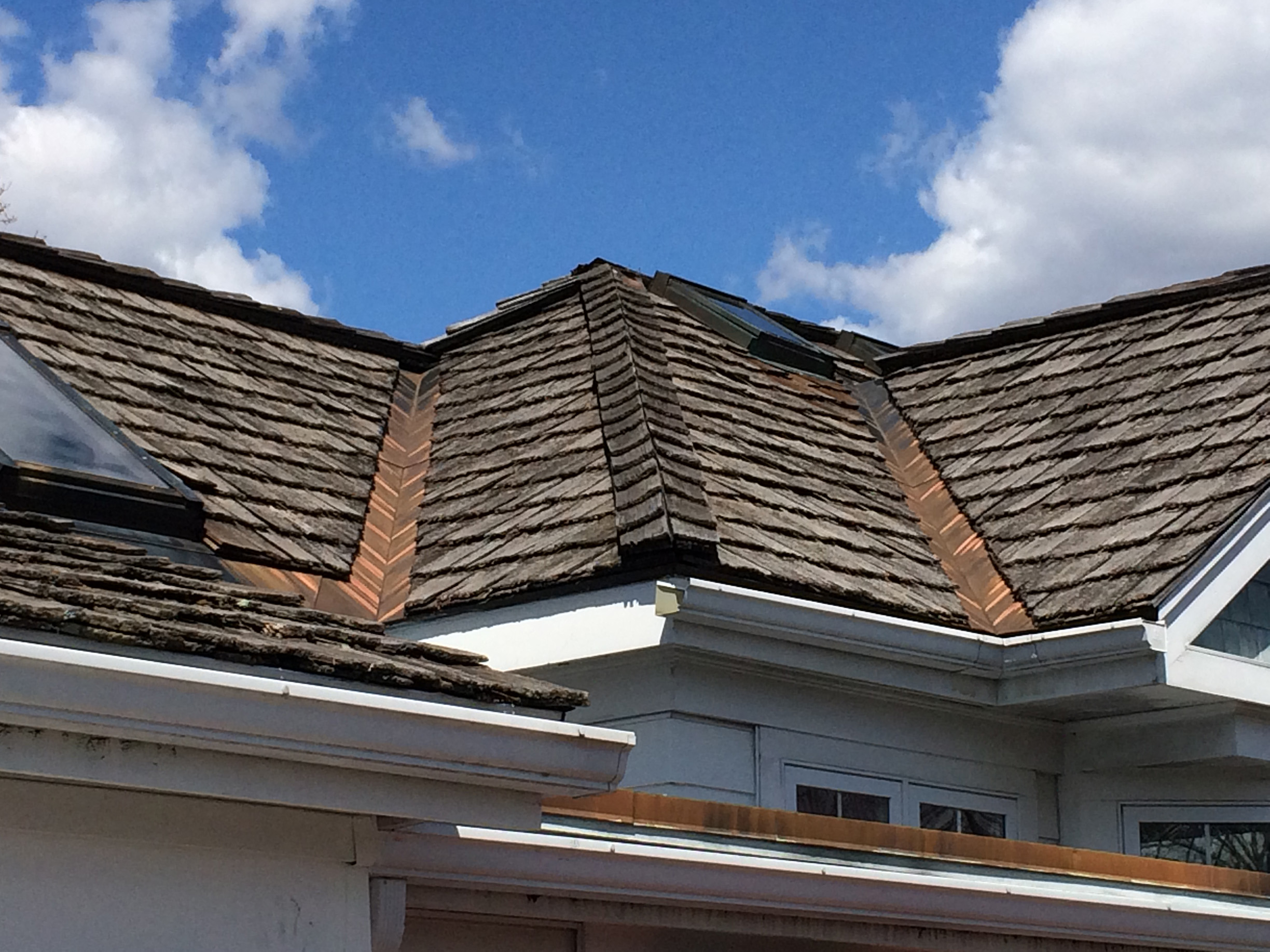 warped cedar shakes on a roof